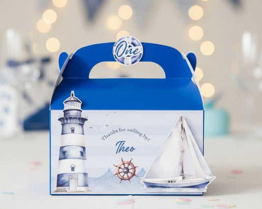 Blue and white sailor nautical theme favour box with a lighthouse design on a blue background